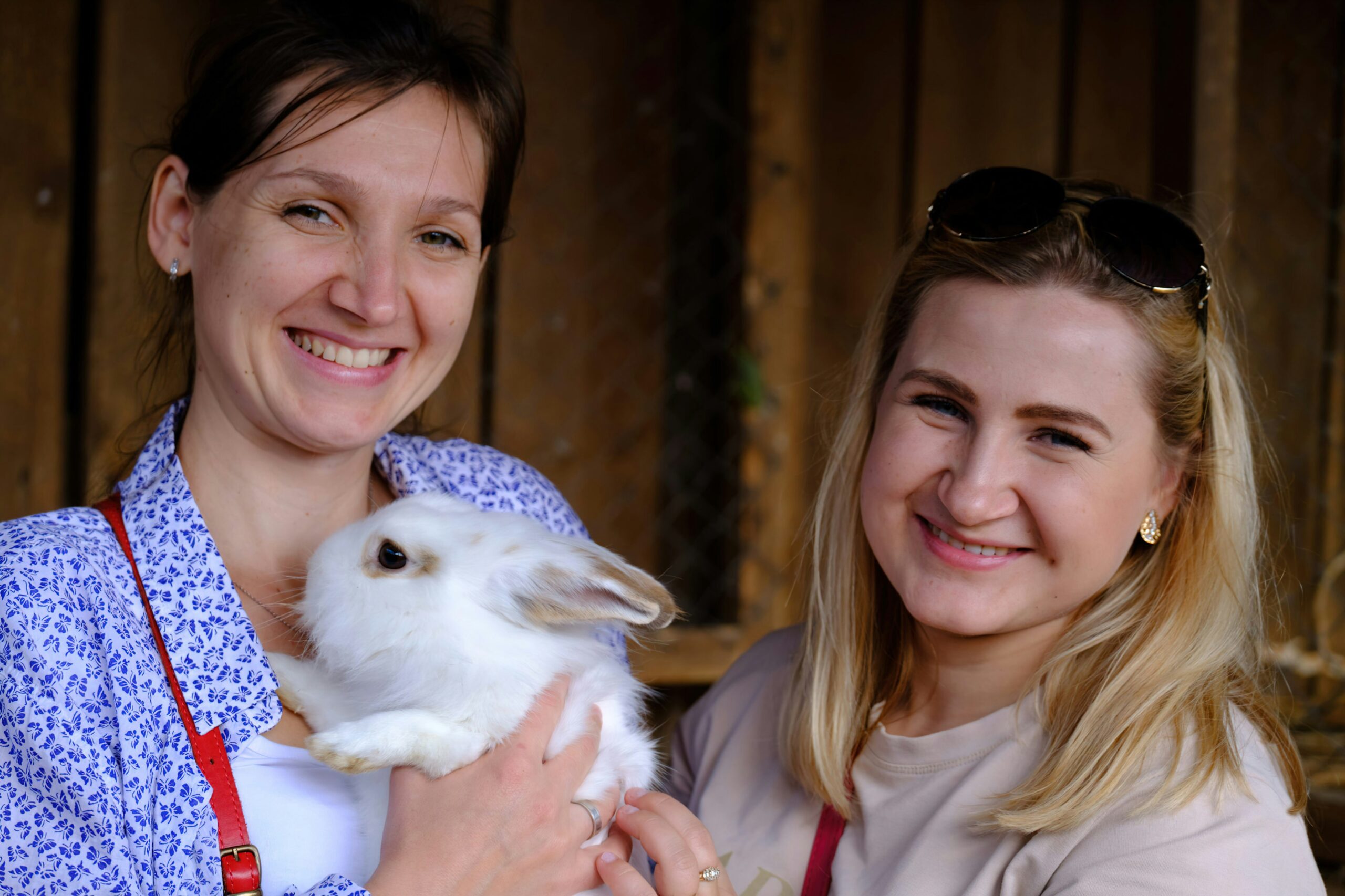 a woman holding a white rabbit in her arms